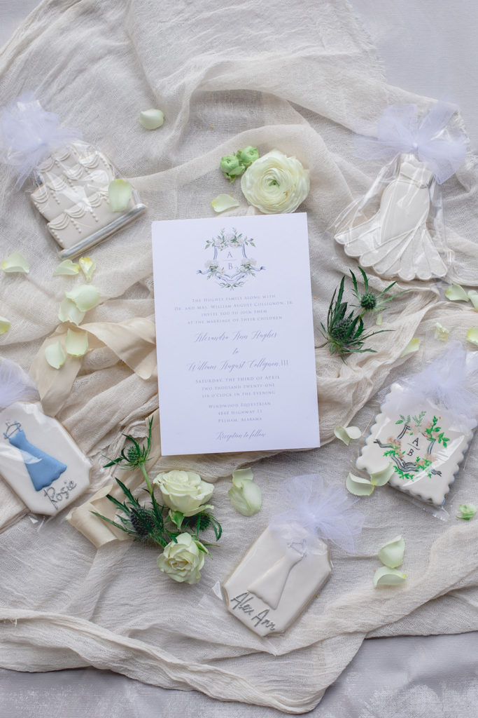 A flatlay of the wedding invitation and wedding day details
