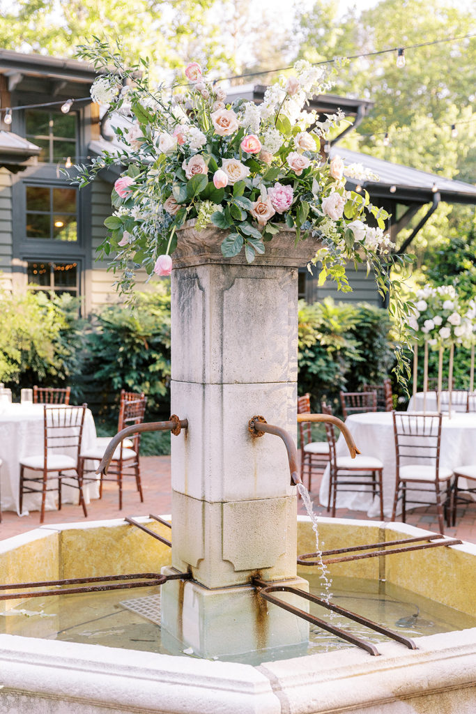 reception planning of a courtyard at the venue featuring a floral arrangement